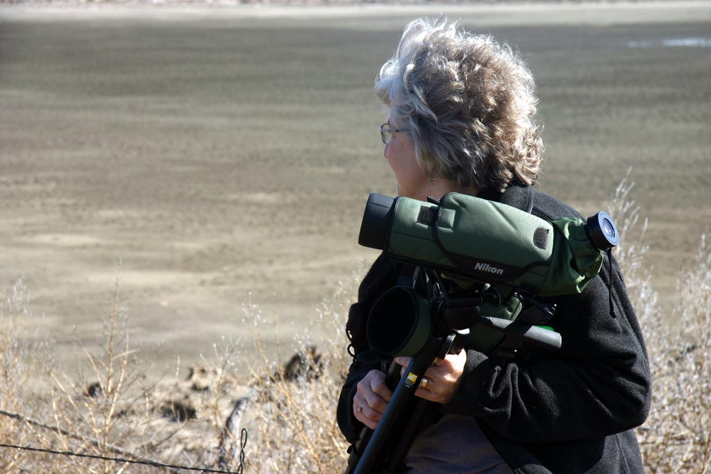Suzanne with scope during bird watching trip for blog post.